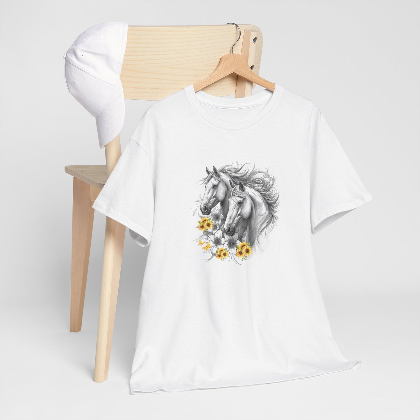 White t-shirt with horse and flower design on a wooden chair against a white background