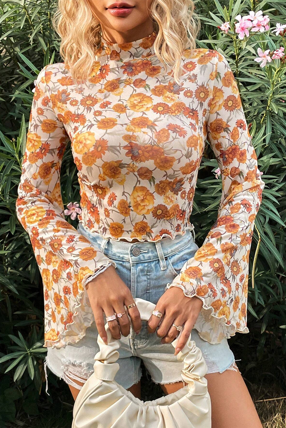 Woman wearing a floral blouse with long sleeves in an outdoor setting