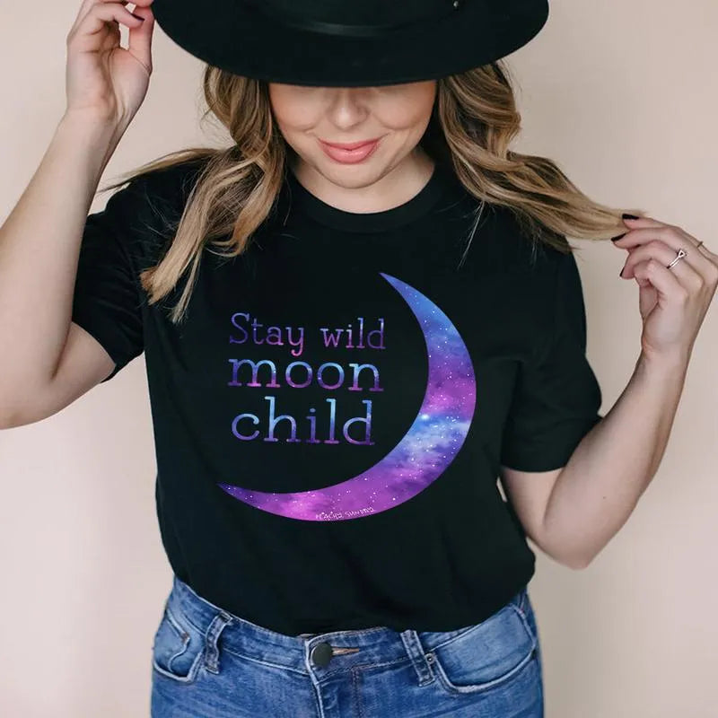 Person wearing a black t-shirt with 'Stay wild moon child' design and a black hat.
