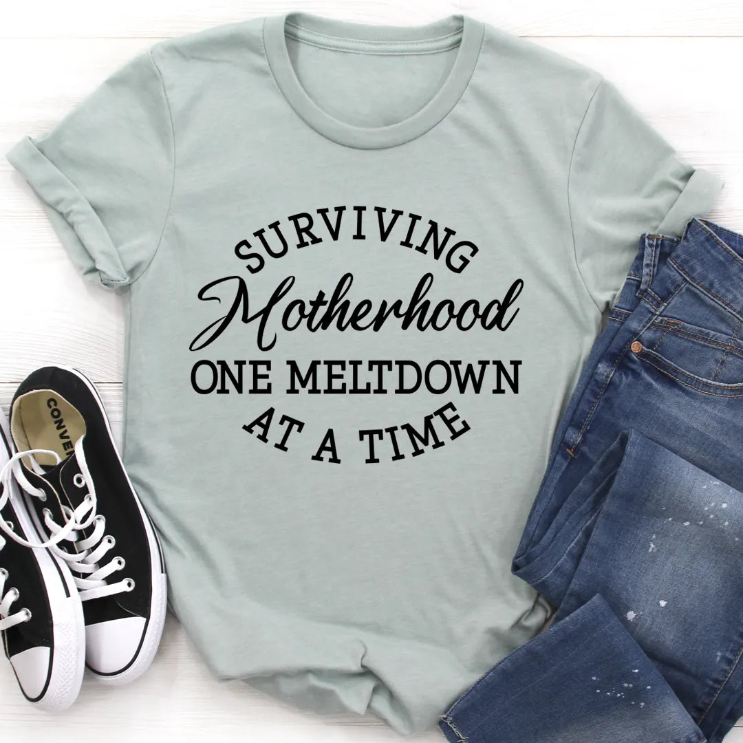 Light blue t-shirt with humorous text design, paired with jeans and sneakers on a white background
