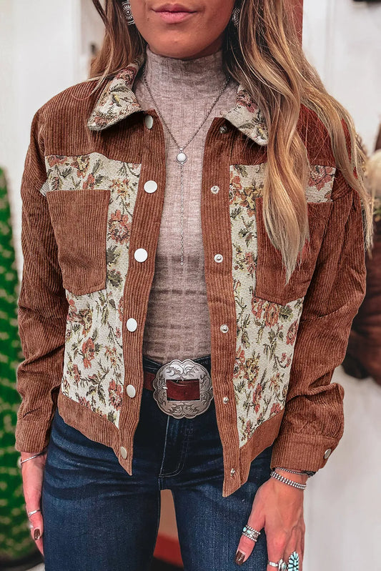 Person wearing a brown floral patchwork jacket with a neutral background