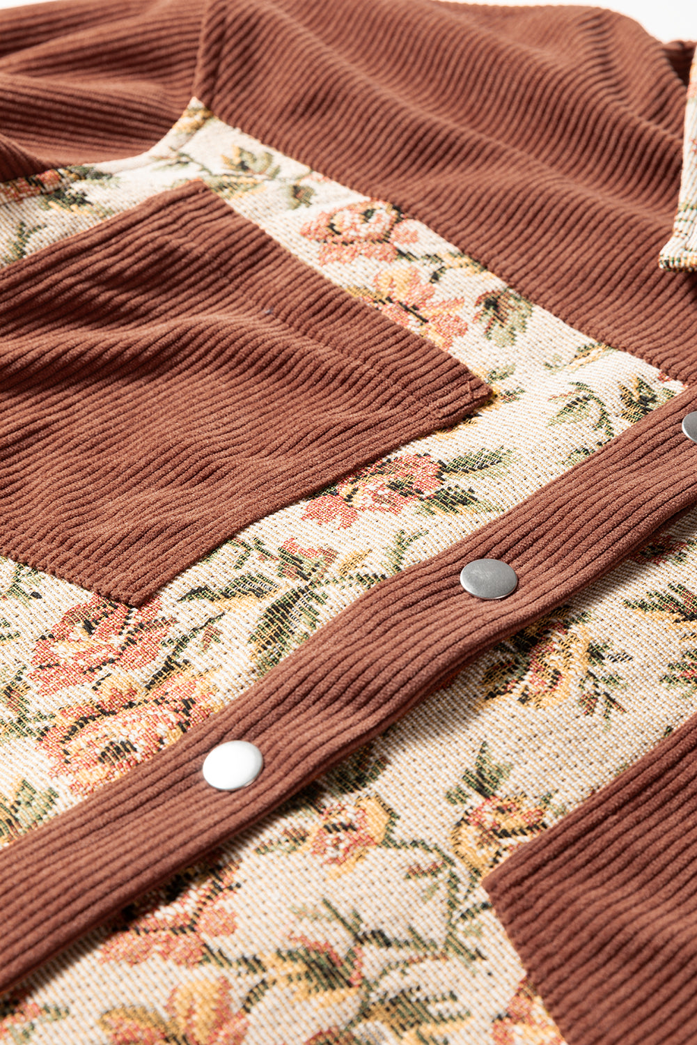 A photo of the front ribbed jacket with front breast pocket, snap buttons and floral patch work.