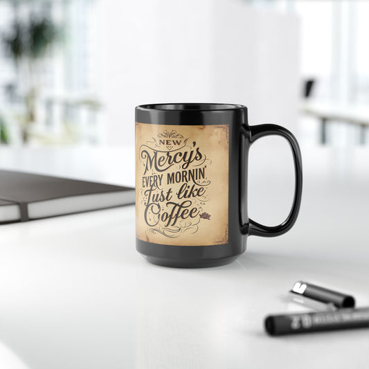 Black mug with vintage-style text design on a white surface with office items.