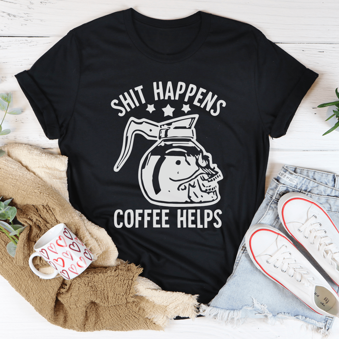 Black t-shirt with a graphic design and text on a white surface with casual items.