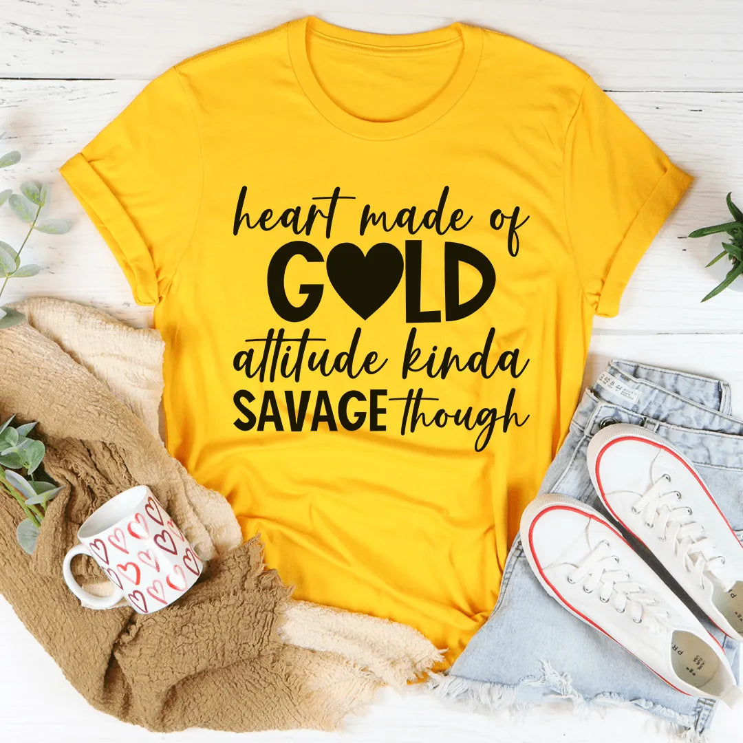 Yellow t-shirt with black text on a white surface with casual items around