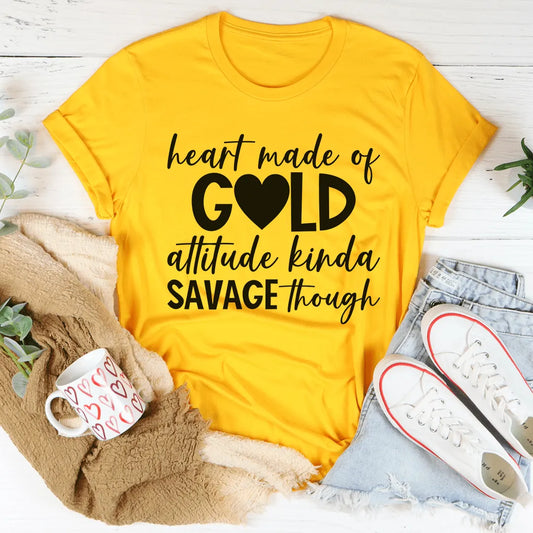 Yellow t-shirt with black text on a white surface with casual items around