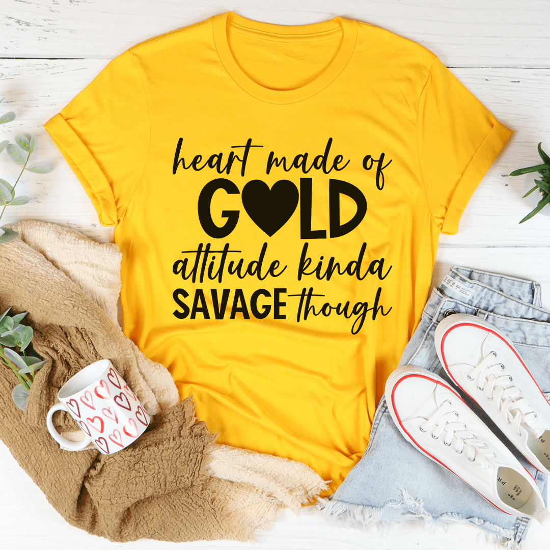 Yellow t-shirt with black text on a white surface with accessories.