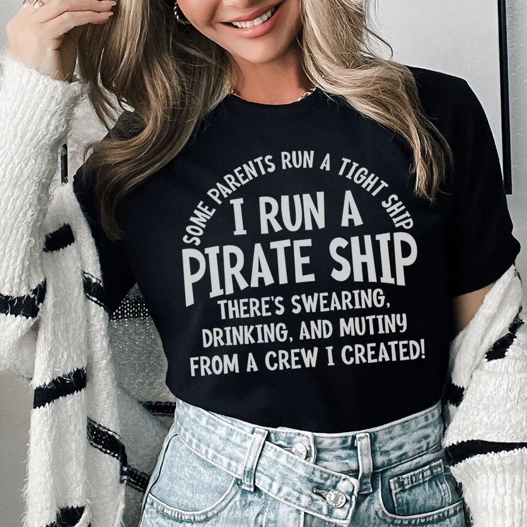 Person wearing a black t-shirt with humorous text design, standing against a neutral background.