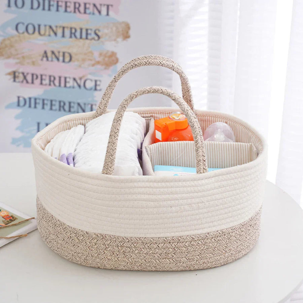 Beige woven basket with baby items on a white surface
