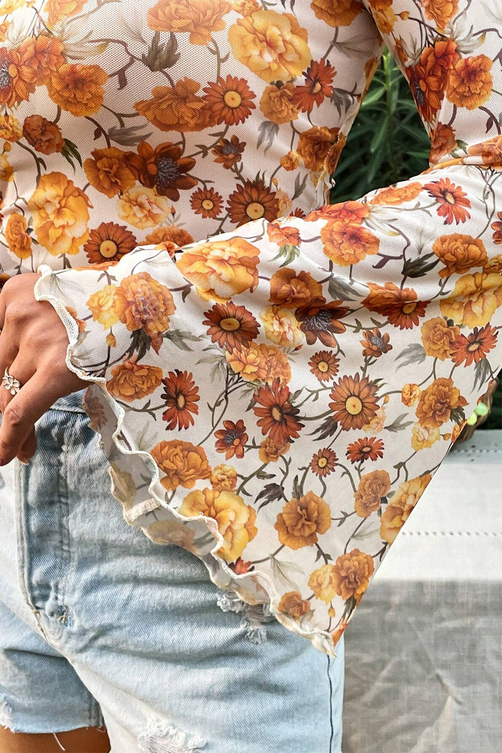 Floral patterned fabric with orange and brown flowers on a white background