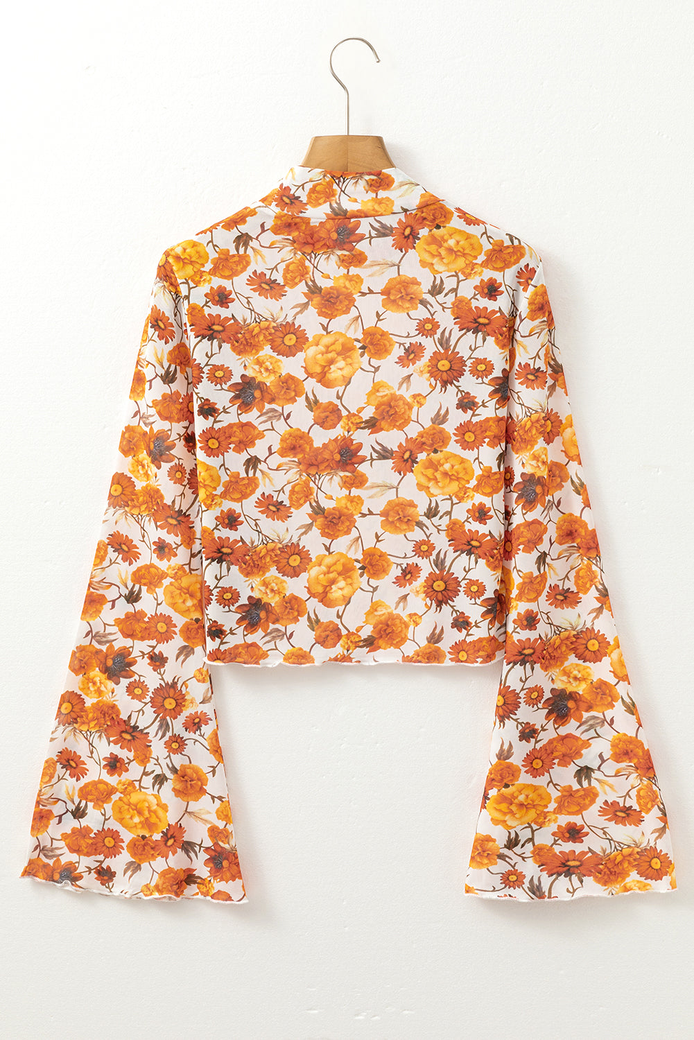 Floral-patterned outfit on a hanger against a white background