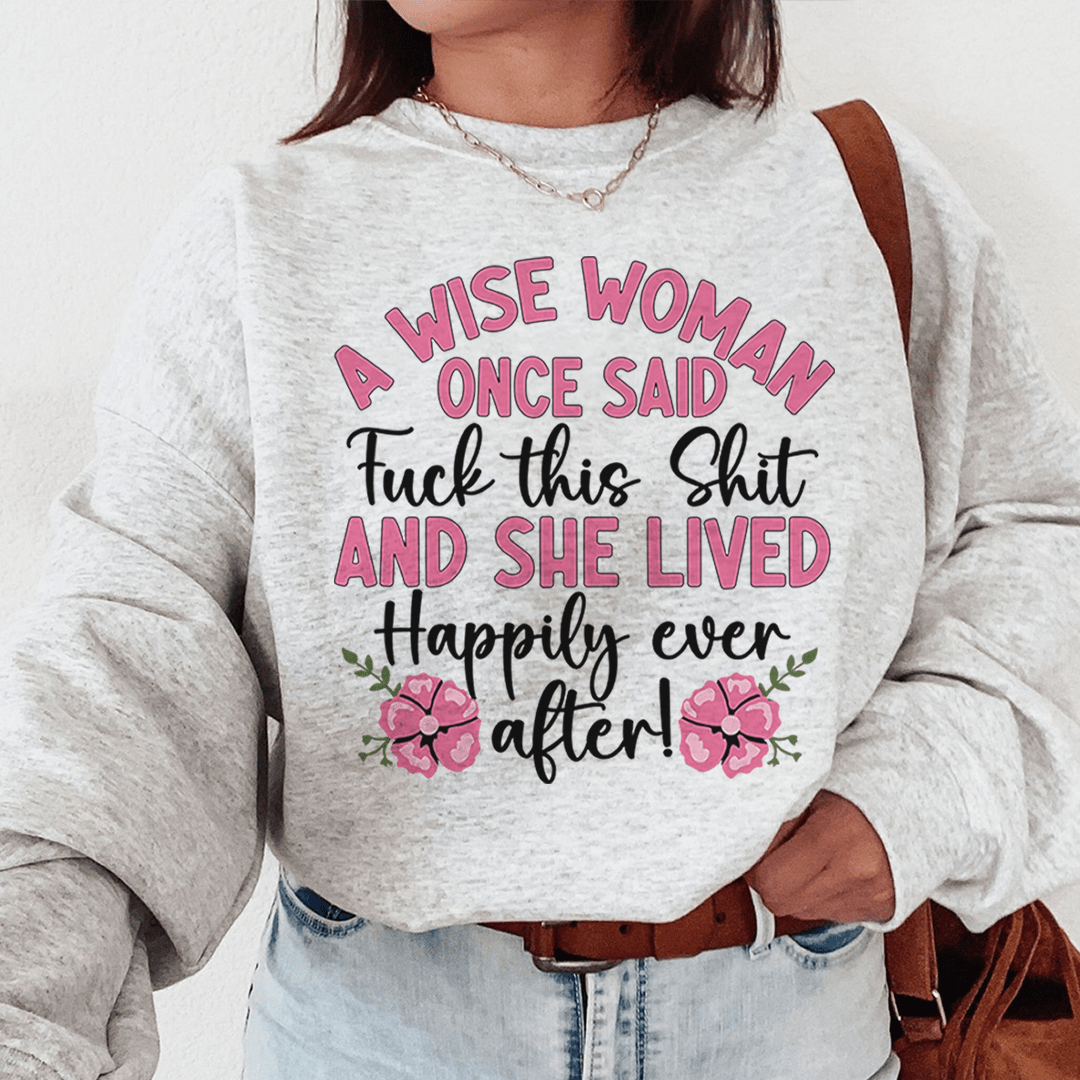 Person wearing a sweatshirt with a humorous quote in pink and black text.